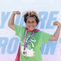 GOTR girl in front of Justice poster at 5K